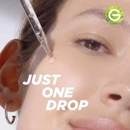 Close-up of woman applying garnier skin naturals serum with dropper on face