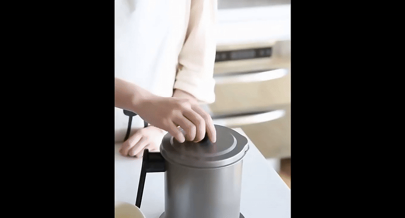 Souqzila oil filter pot with lid used as a cooking oil saver on kitchen countertop