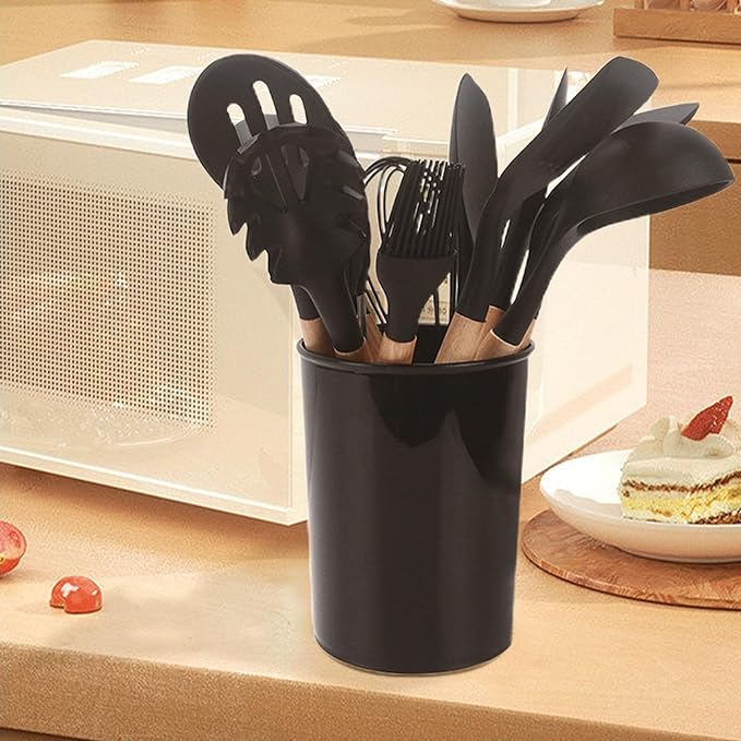 Souqzila heat resistant cooking utensils with black heads and wooden handles in a black holder on kitchen counter