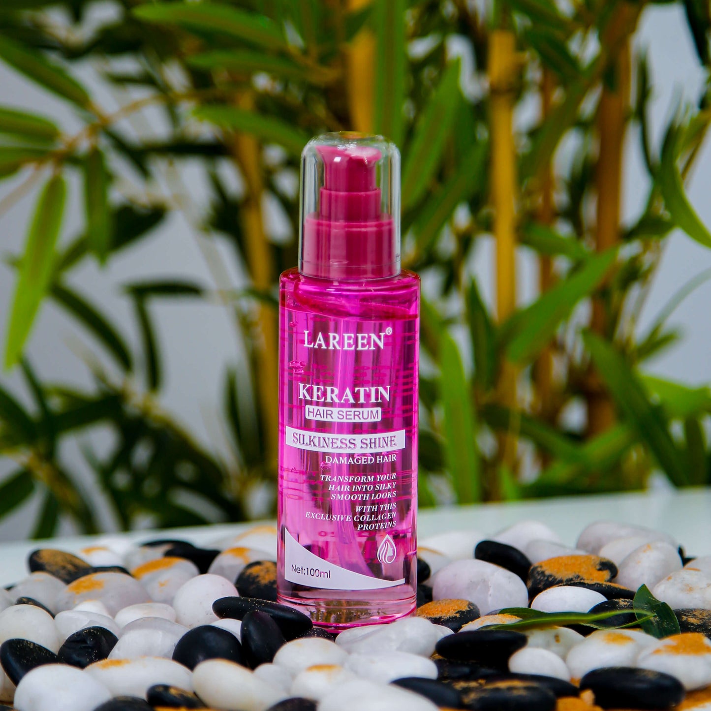 Lareen Keratin Hair Serum by Souqzila in pink bottle placed on white and black stones best hair growth serum