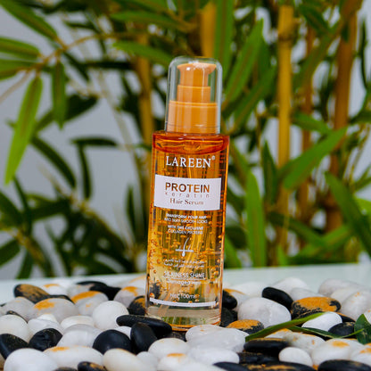 Lareen Hair Serum bottle labeled protein keratin best hair growth serum on decorative stones