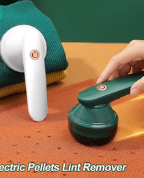 Souqzila portable lint remover in white and green used on sweaters to remove lint and pills