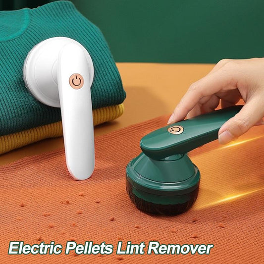 Souqzila portable lint remover in white and green used on sweaters to remove lint and pills