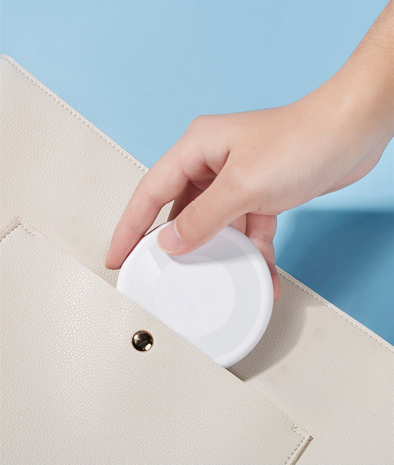 Souqzila 60W fast charging cable compact white round travel case being placed in beige purse pocket
