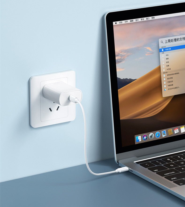 Souqzila 60W fast charging cable connecting white wall adapter to MacBook laptop for fast power delivery